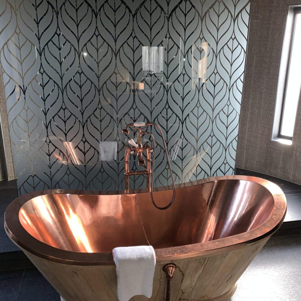 A copper bath installed in a bathroom.