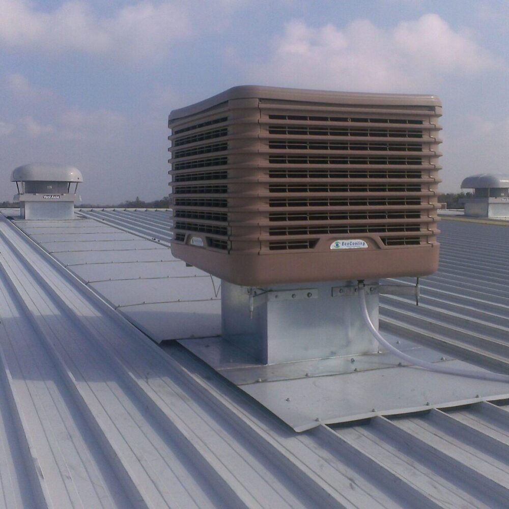 Close up of an evaporative cooling unit on an industrial roof.