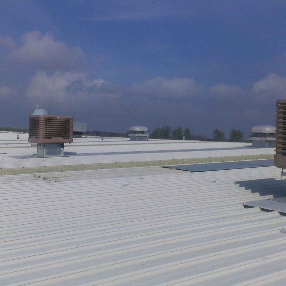 Evaporative cooling units on an industrial roof.