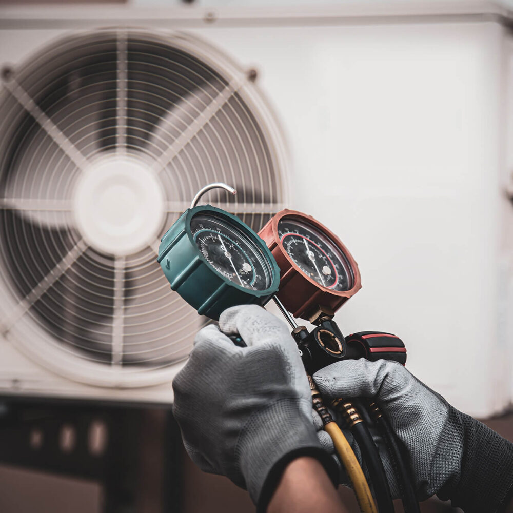 Technician carrying out servicing and maintenance on commercial HVAC system