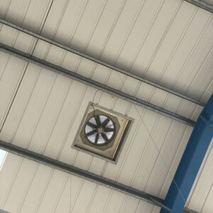 An air conditioning vent installed on the roof of a warehouse.