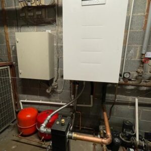 commercial boiler replacement - atag wall hung boiler on brick wall