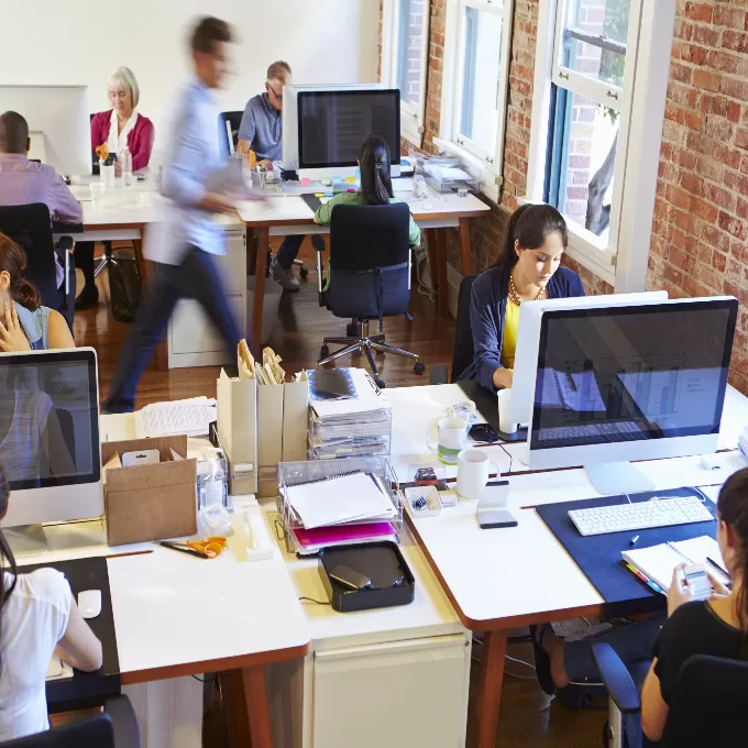 Workers in a small office space.