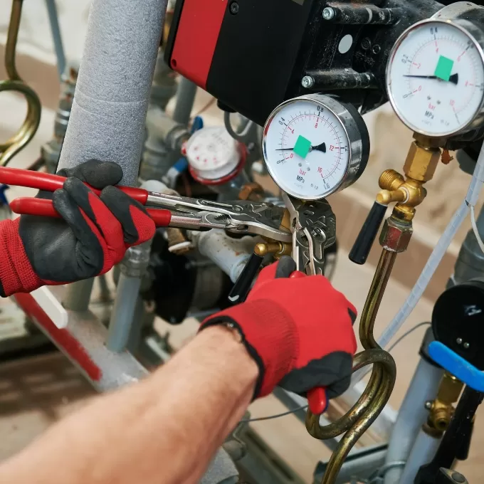 An engineer working on pipework.