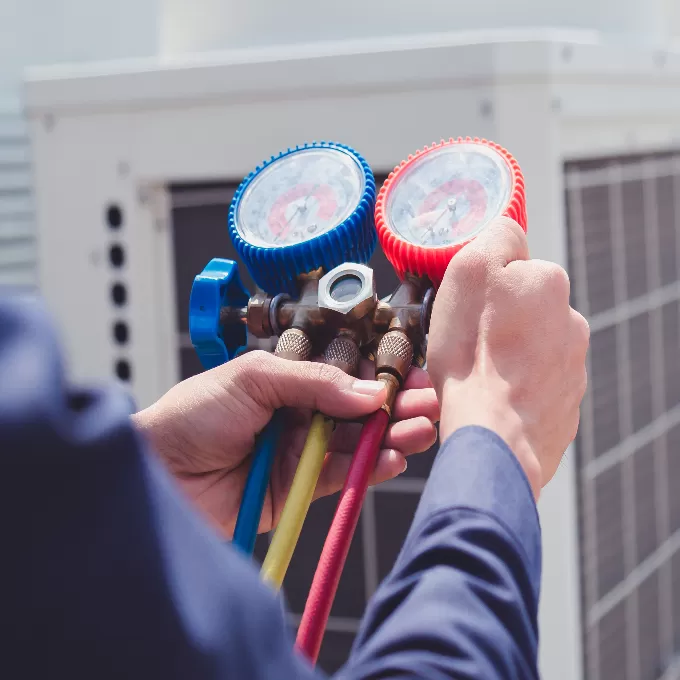 A engineer conducting an air conditioning check.