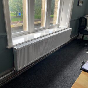 A long radiator located in a downstairs room at Hope House.