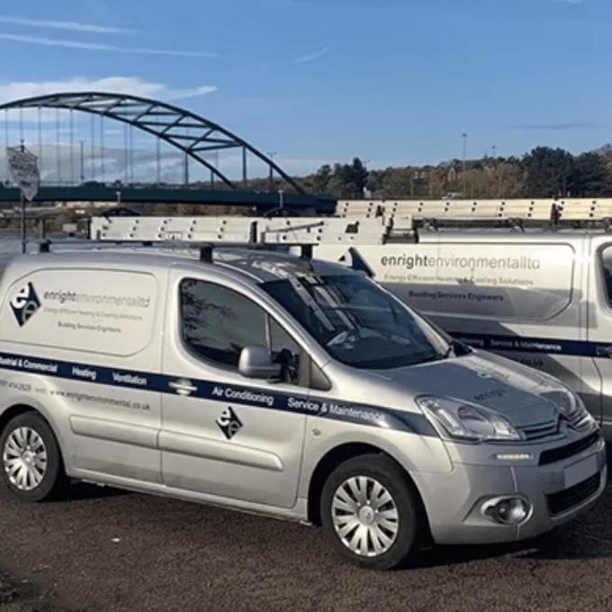 Two Enright Environmental vans parked next to the River Tyne.