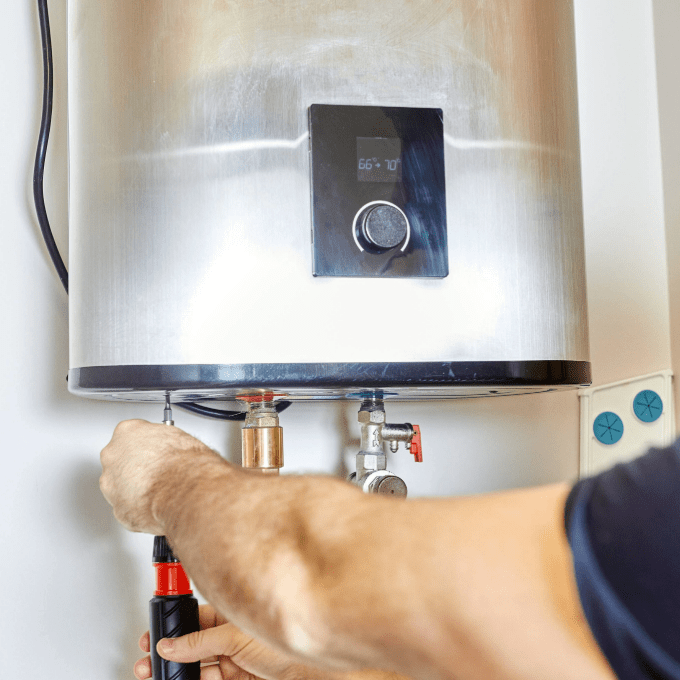 Man completing maintenance on a commercial hot water system.