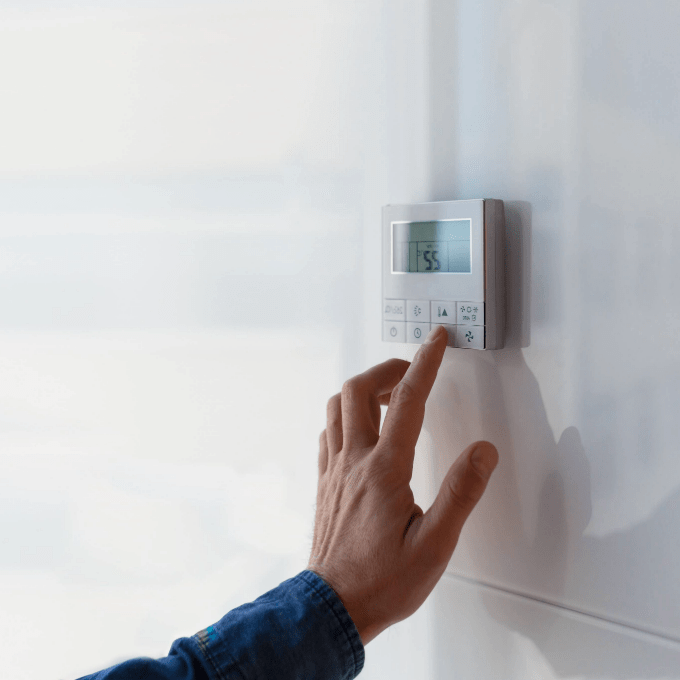 The air conditioning and heating control panel for an office located on a white wall.