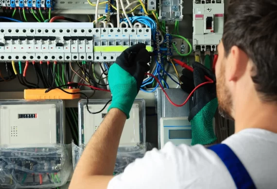 An electrical conducting an inspection on the electric wiring in a commercial building.