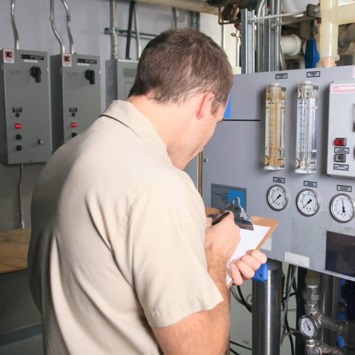 A professional conducting a boiler maintenance inspection for a business, ensuring safety and compliance.