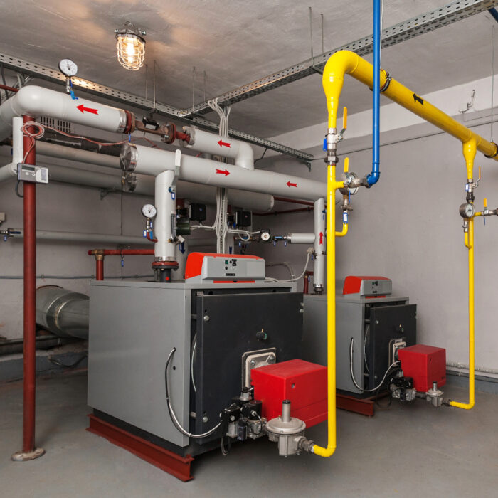 A modern-looking commercial boiler in a commercial boiler room.